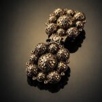Kniazha Chepraha clasp, angled view showing the domed rosettes